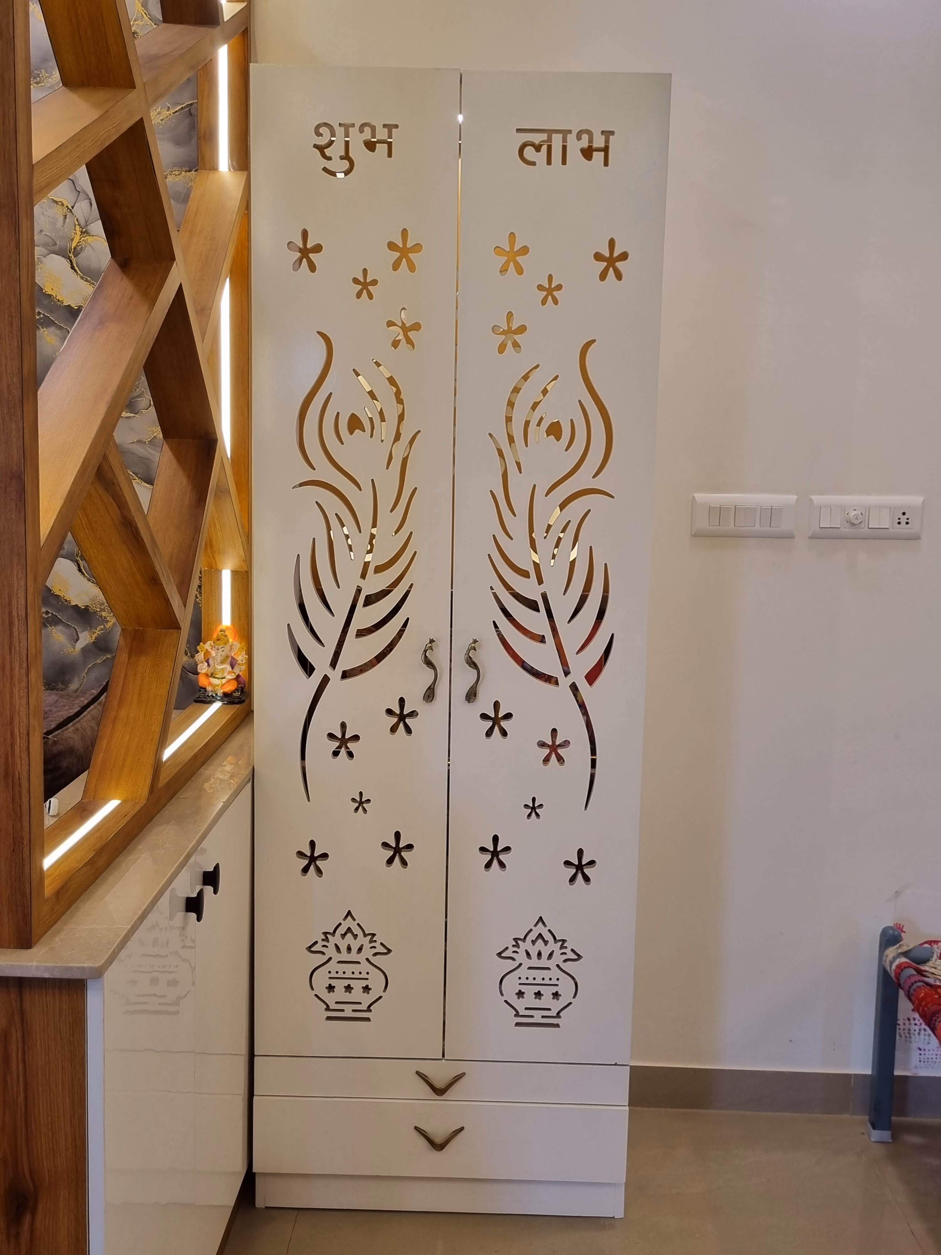 Carved puja room doors with gold fretwork panels