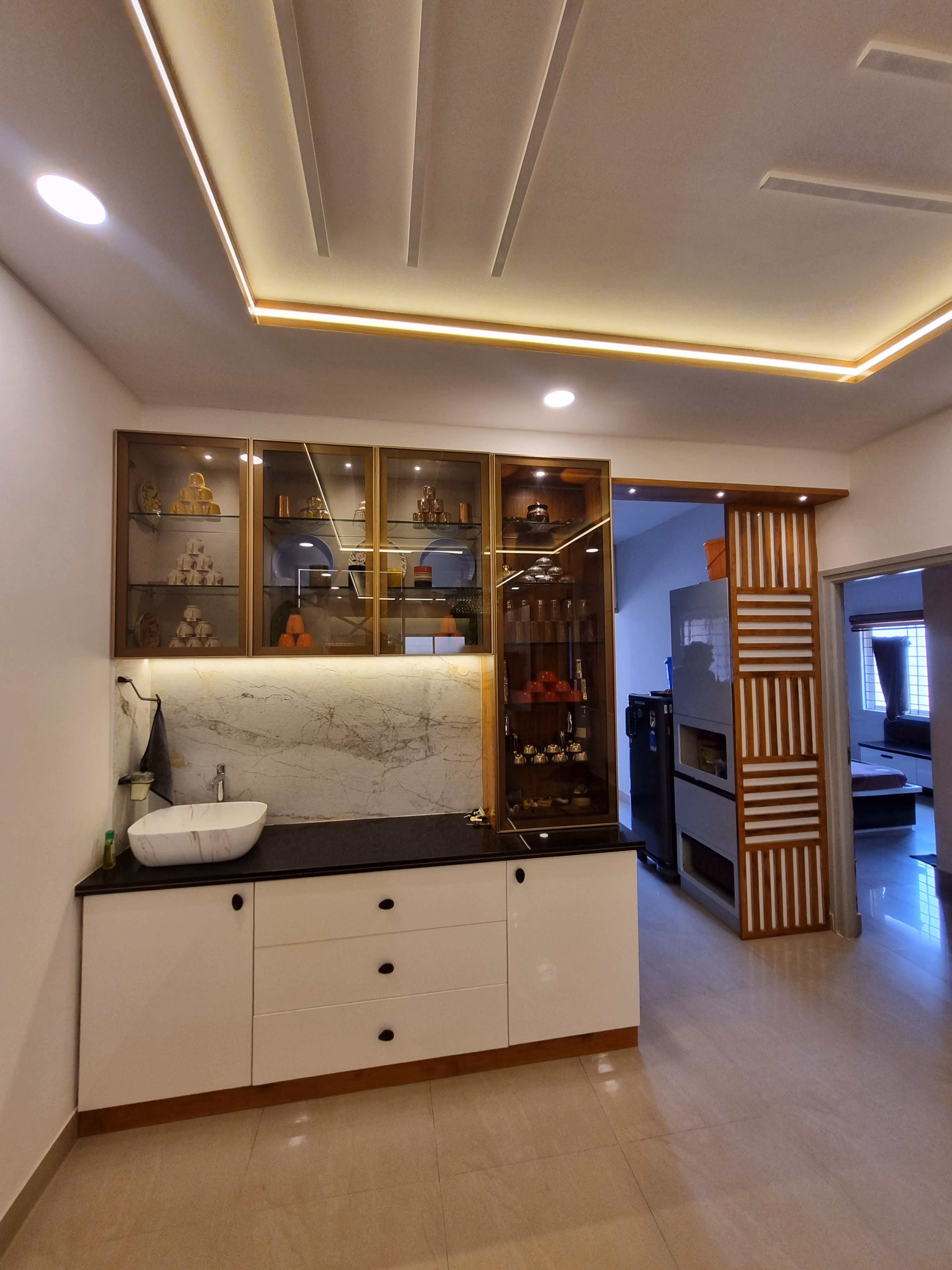 Crockery unit with fluted panelling beside the dining area