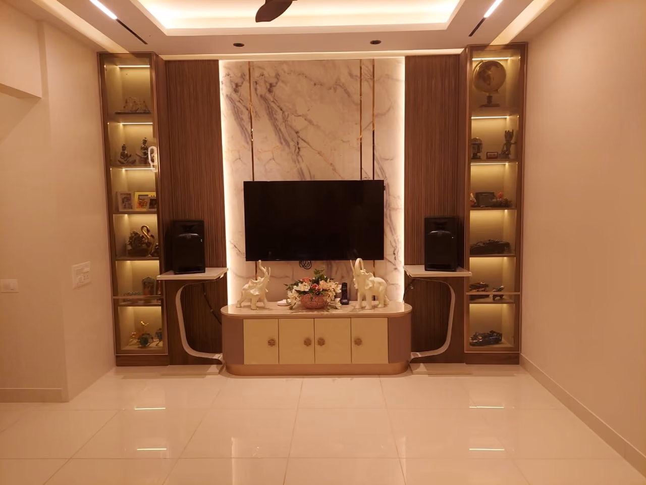 Backlit marble TV unit with brass-trimmed display niches