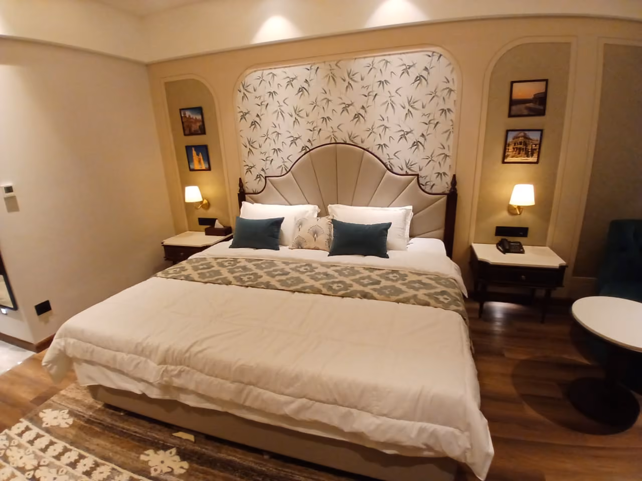 Bedroom with a carved headboard and matching bedside units